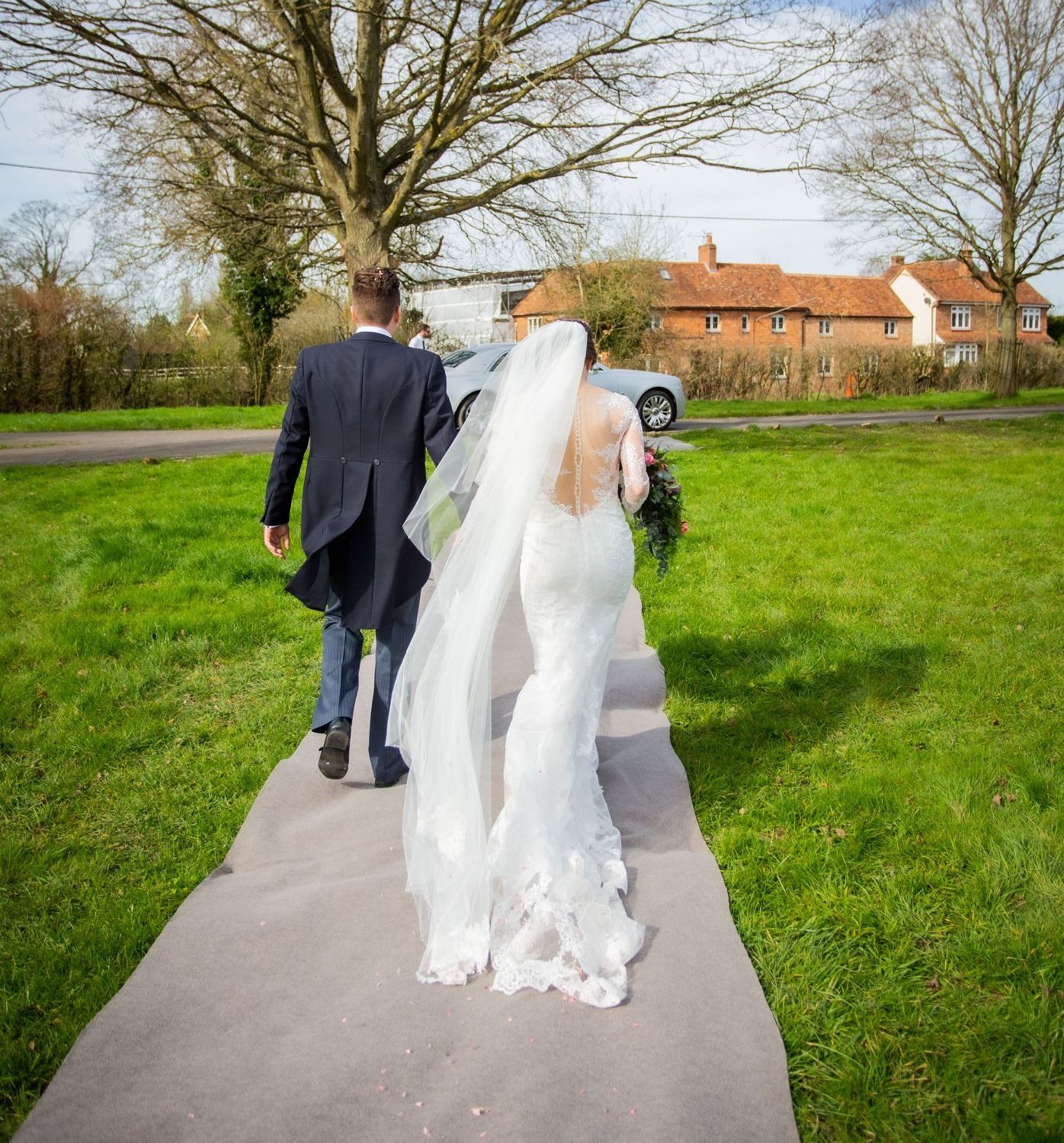 Сouple wearing a white gown and a black suit