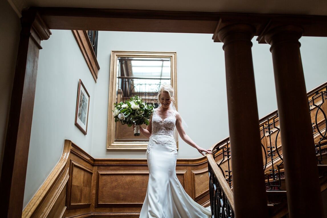 Model wearing a white gown on the stairs